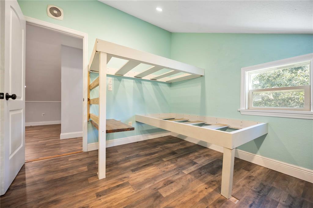 7348 Coach Road Port Charlotte, FL 33981 - Photo 27 of 48 a workspace with wooden floor