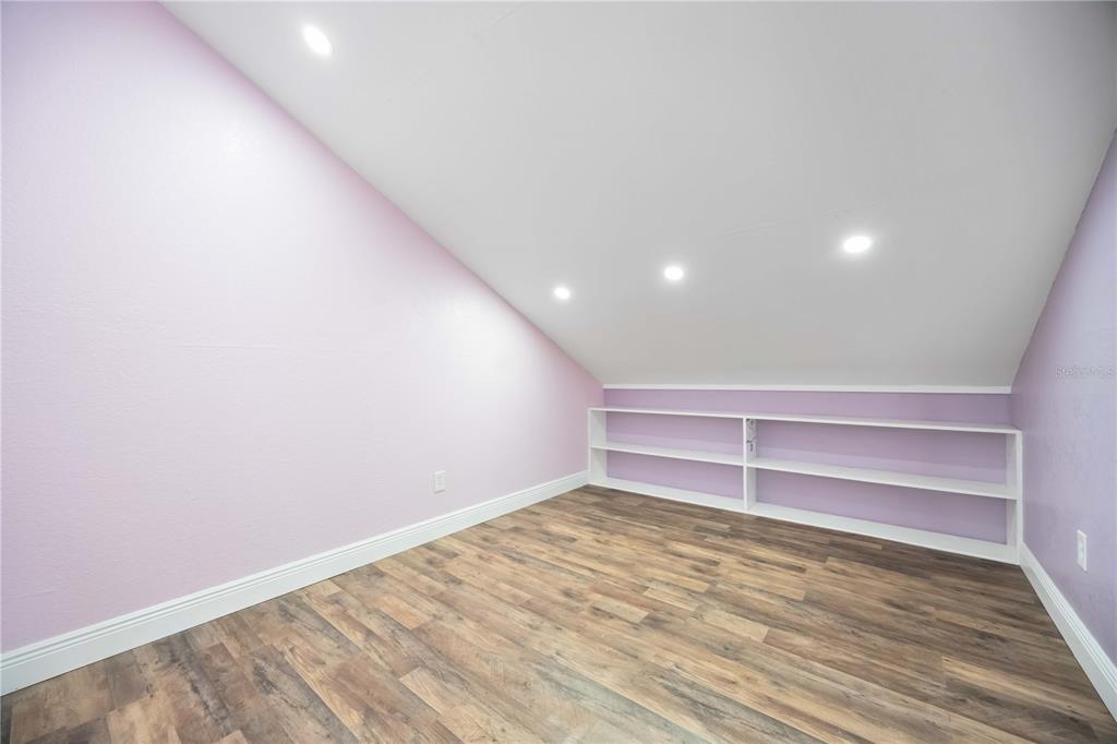 7348 Coach Road Port Charlotte, FL 33981 - Photo 28 of 48 a view of room with wooden floor and fan