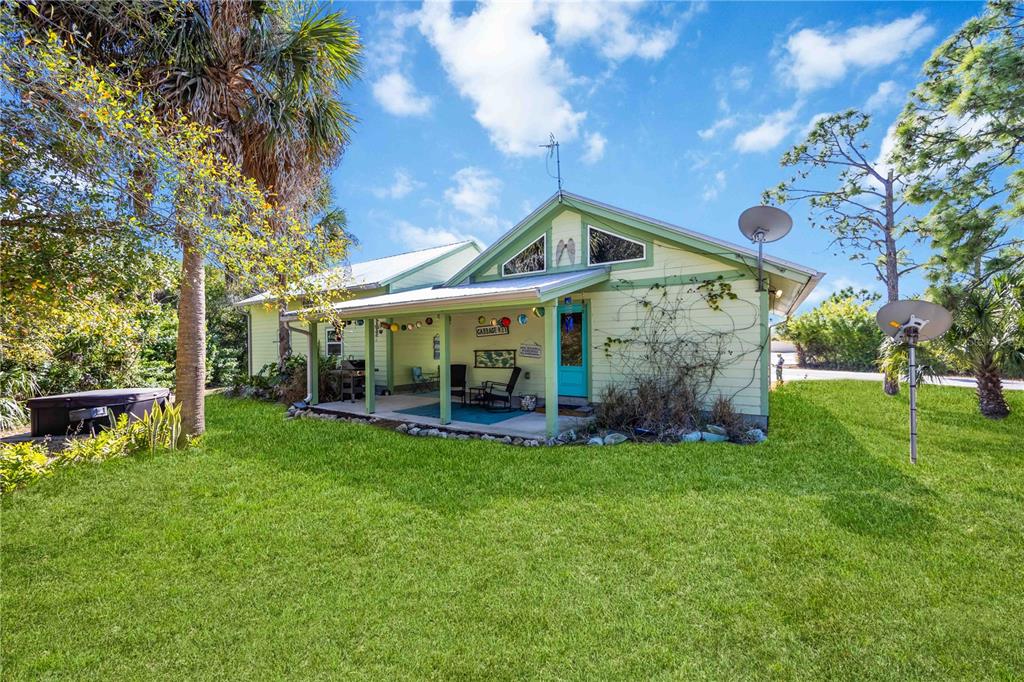 7348 Coach Road Port Charlotte, FL 33981 - Photo 34 of 48 a view of a house with a yard and sitting area