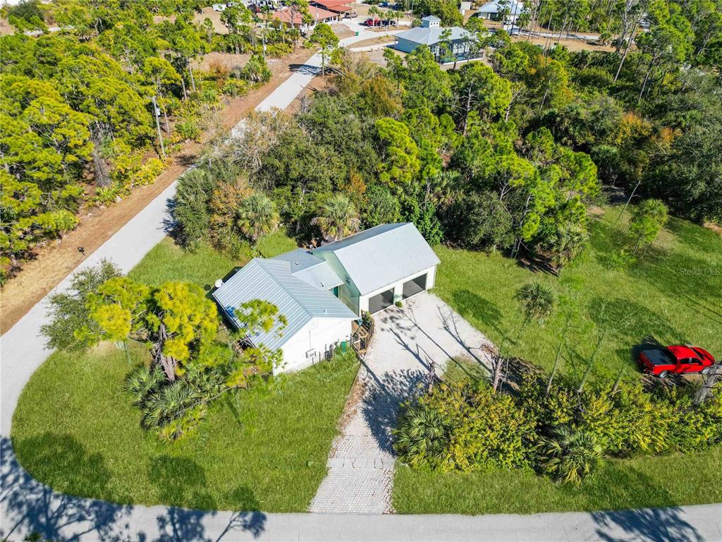 7348 Coach Road Port Charlotte, FL 33981 - Photo 38 of 48 an aerial view of a house with a yard and large trees