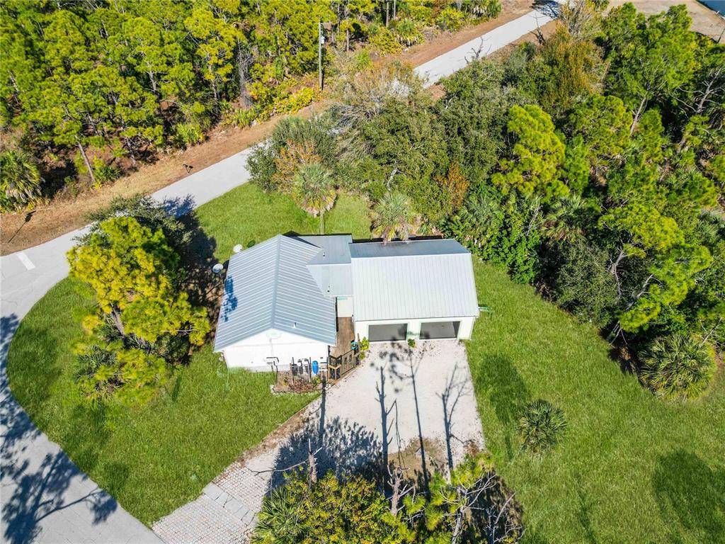 7348 Coach Road Port Charlotte, FL 33981 - Photo 40 of 48 a aerial view of a house with a yard and large trees