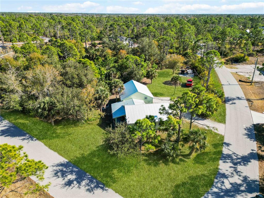 7348 Coach Road Port Charlotte, FL 33981 - Photo 42 of 48 a view of a garden with a building in the background