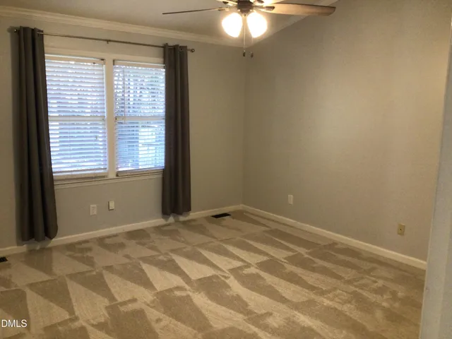 a view of a chair and table in backyard of the house