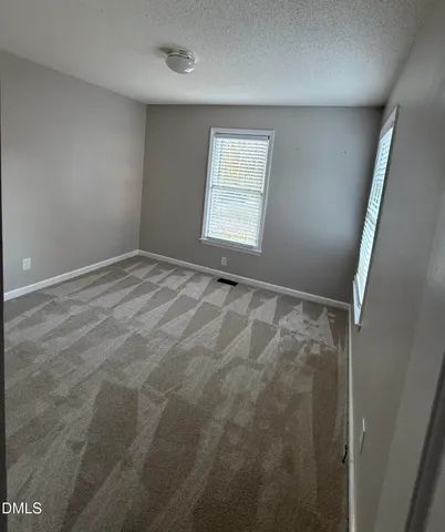 a balcony with wooden floor and furniture