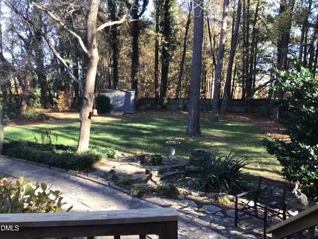 a view of a backyard with a garden and trees