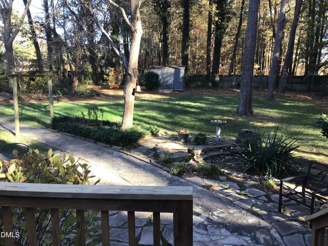 a view of a wooden deck and a backyard