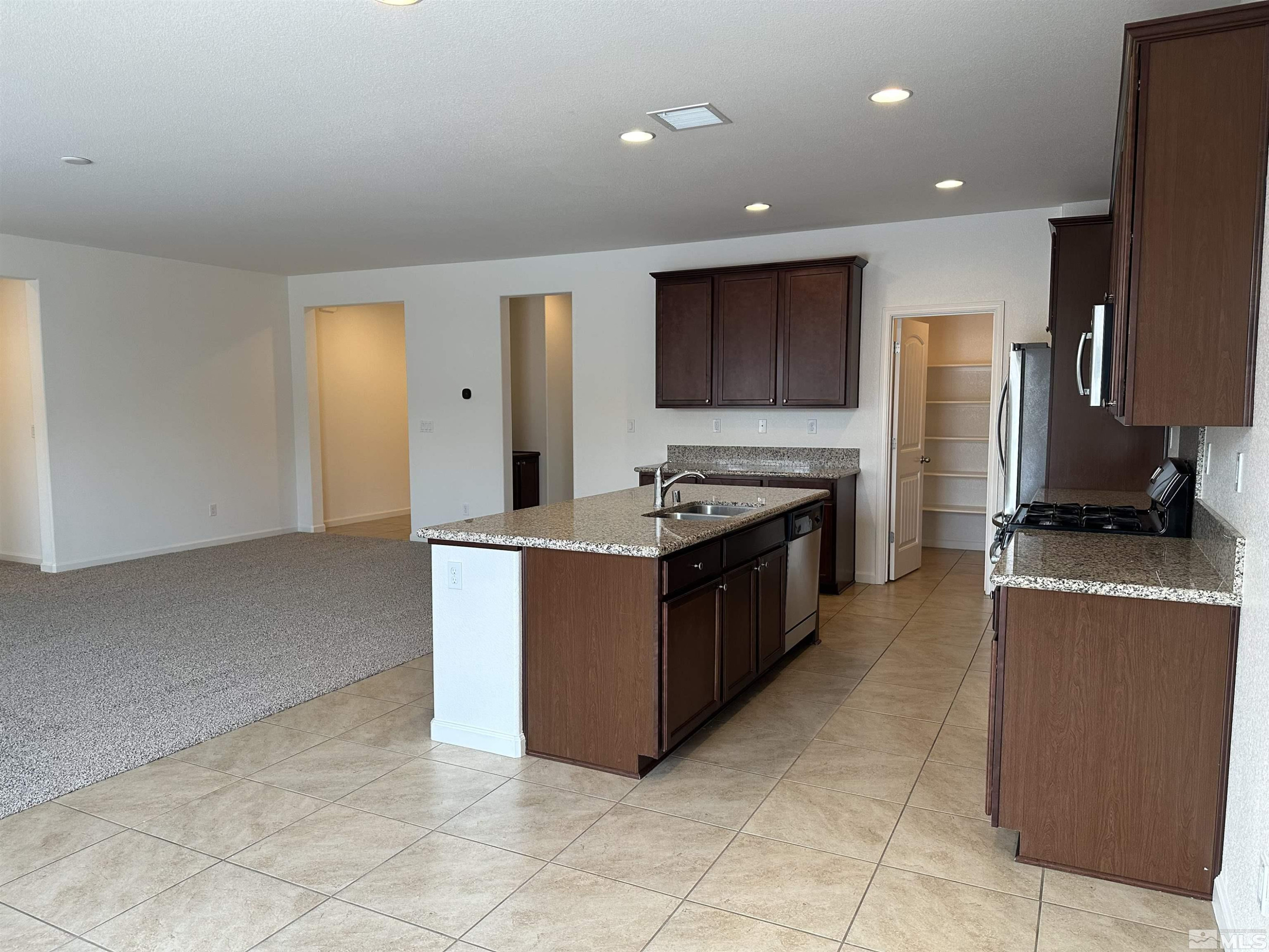 1960 Dutch Draft Drive Reno, NV 89521 - Photo 11 of 23 a large kitchen with stainless steel appliances granite countertop a stove and a refrigerator