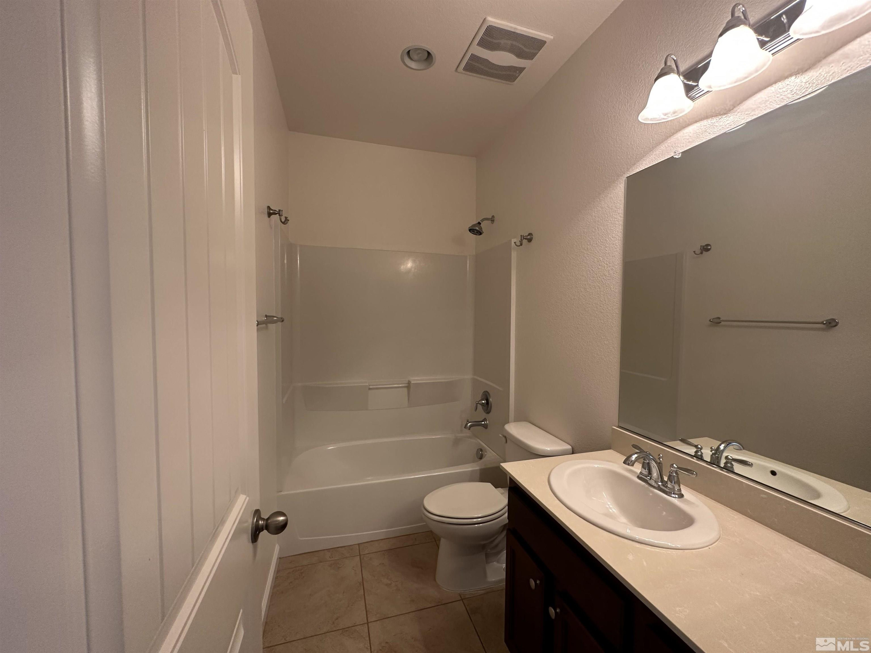 1960 Dutch Draft Drive Reno, NV 89521 - Photo 5 of 23 a bathroom with a granite countertop sink toilet a mirror and shower