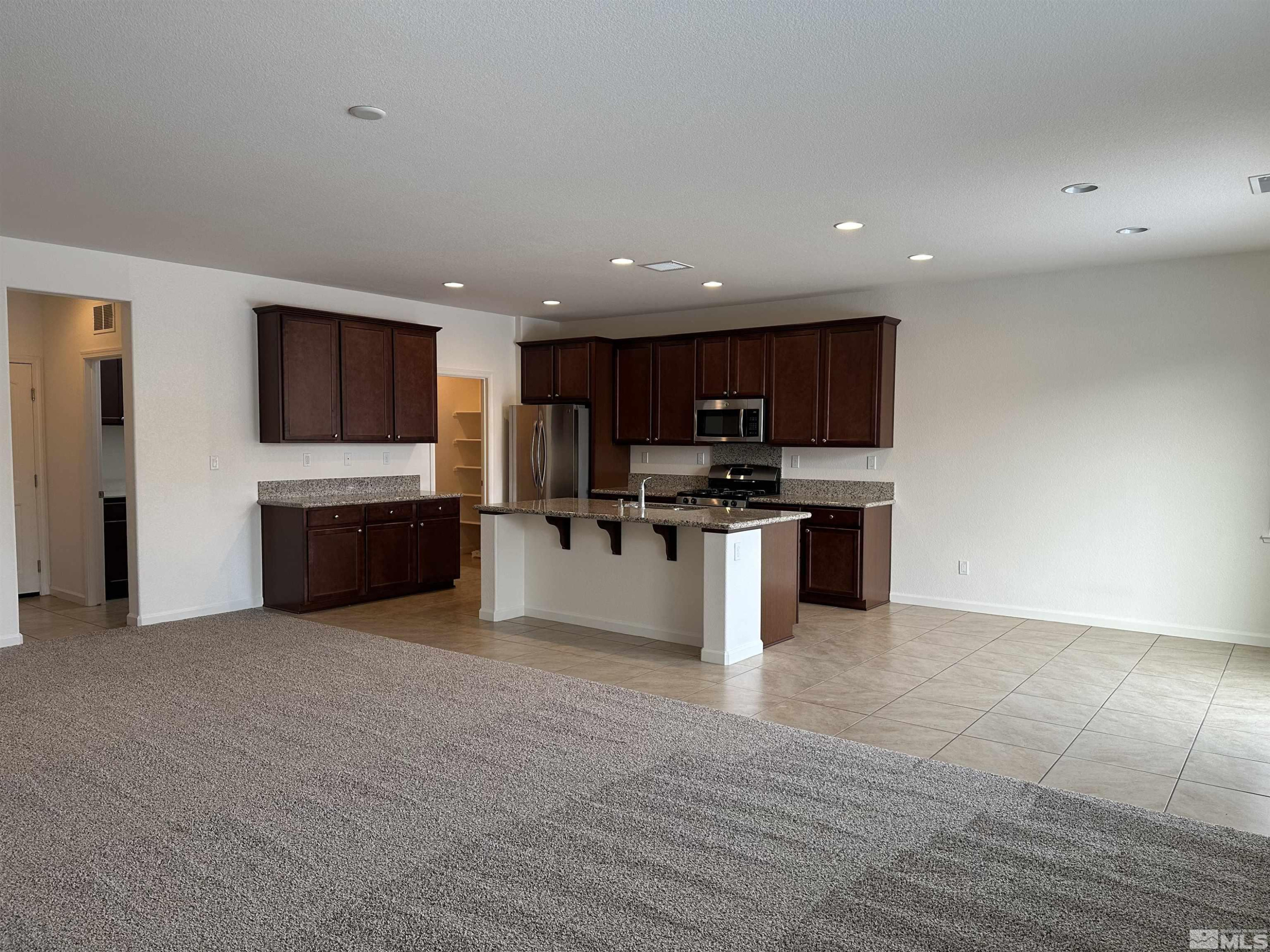 1960 Dutch Draft Drive Reno, NV 89521 - Photo 10 of 23 a view of kitchen with microwave oven a stove and cabinets