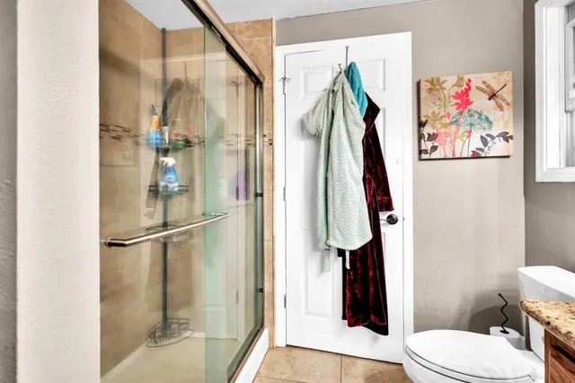 a bathroom with a shower and a toilet