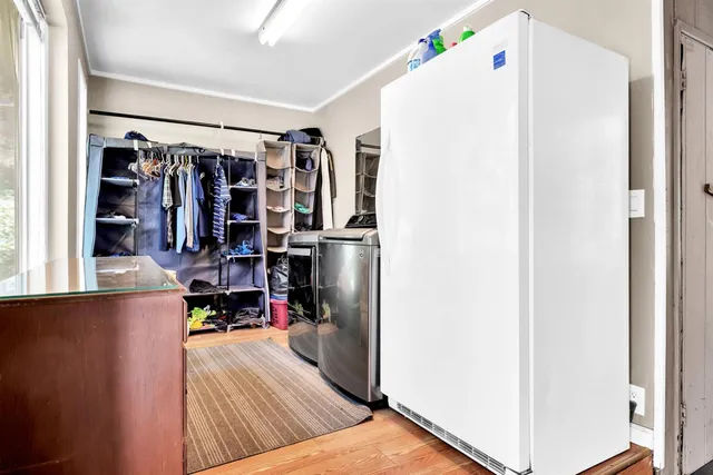 a view of a street with trees and bushes