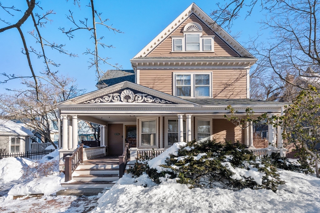 a front view of a house with garden and porch