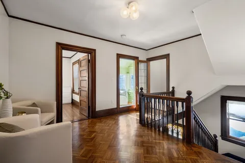 a view of a livingroom with furniture and hardwood floor