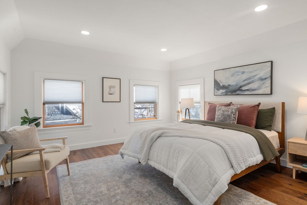 16 Prescott Street Newton, MA 02460 - Photo 17 of 29 a bedroom with a bed a table and chair