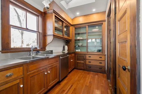a kitchen with stainless steel appliances granite countertop cabinets and wooden floor