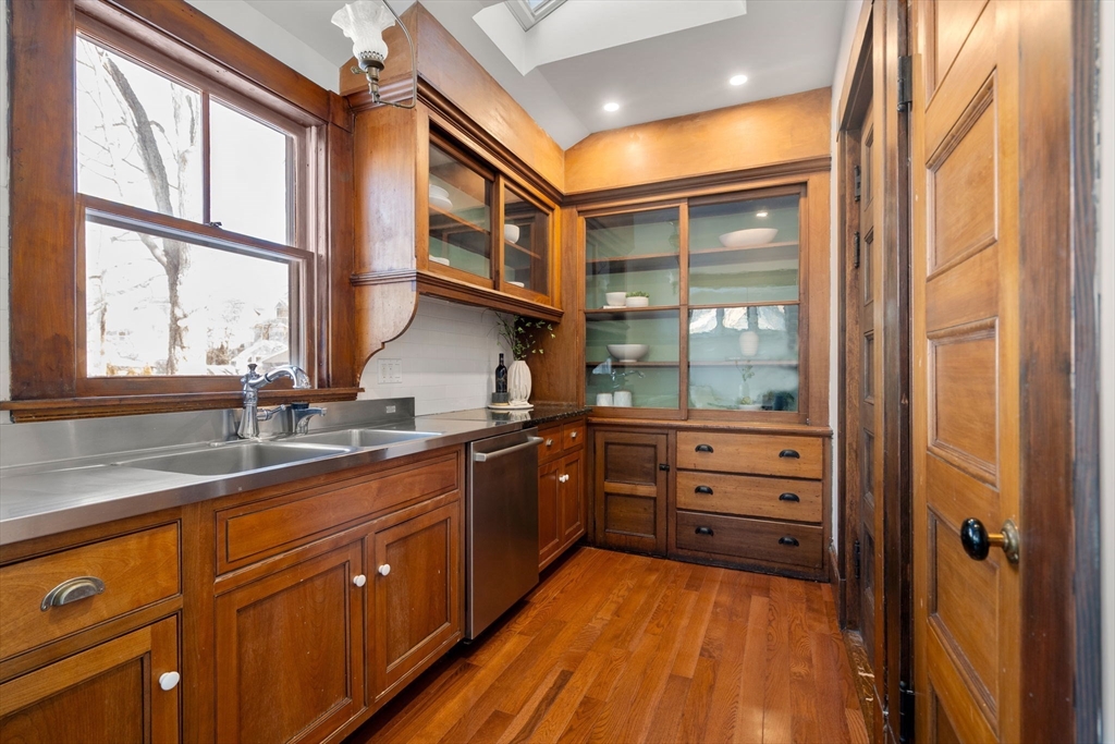 16 Prescott Street Newton, MA 02460 - Photo 6 of 29 a kitchen with stainless steel appliances granite countertop cabinets and wooden floor