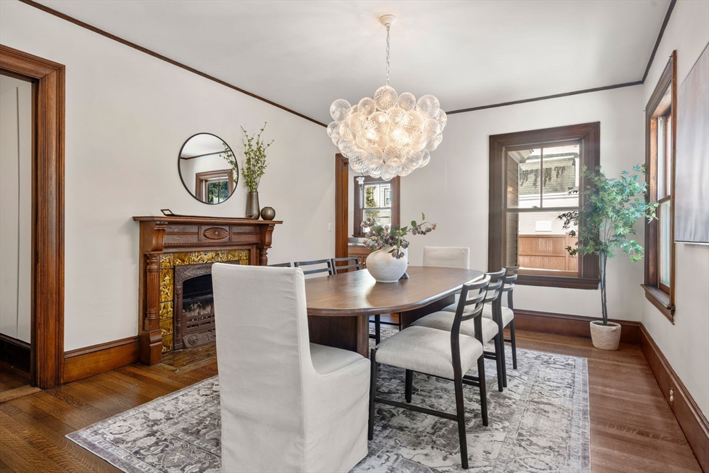 16 Prescott Street Newton, MA 02460 - Photo 7 of 29 a view of a dining room with furniture a chandelier and wooden floor