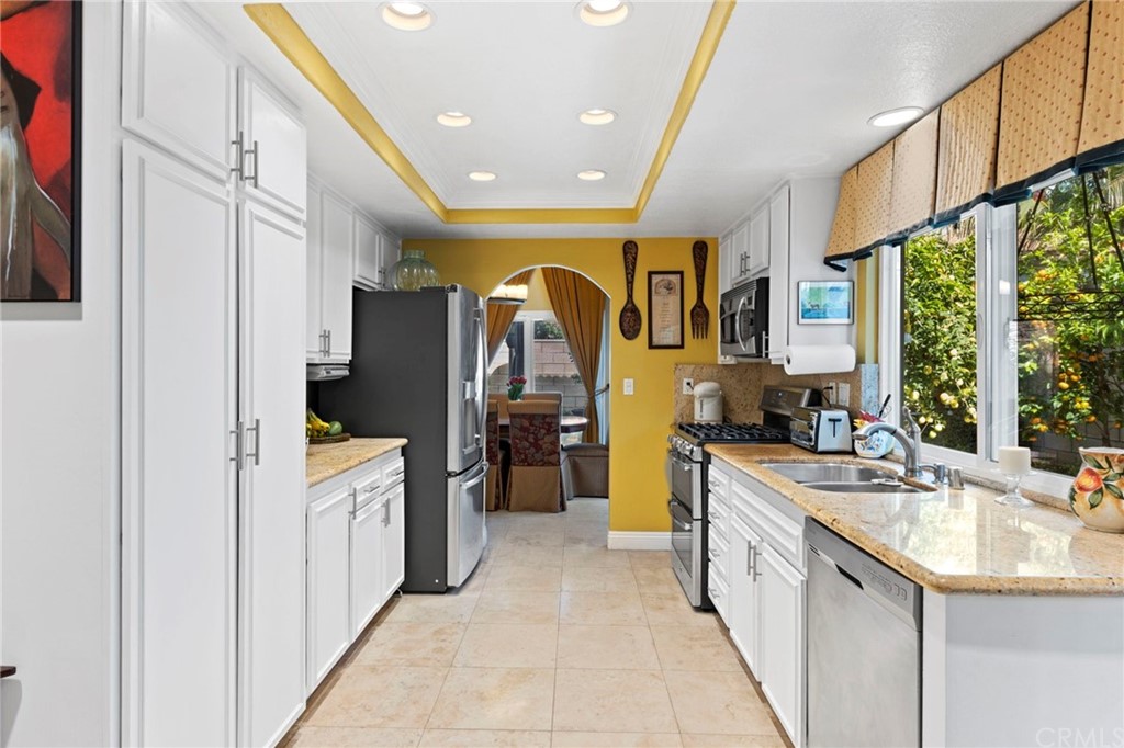 15 Calandria Irvine, CA 92620 - Photo 13 of 49 a kitchen with stainless steel appliances granite countertop a sink and cabinets