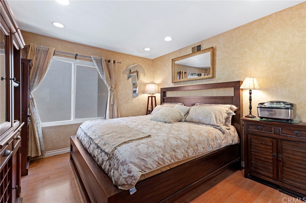 15 Calandria Irvine, CA 92620 - Photo 29 of 49 a bedroom with a bed lamps and a large mirror