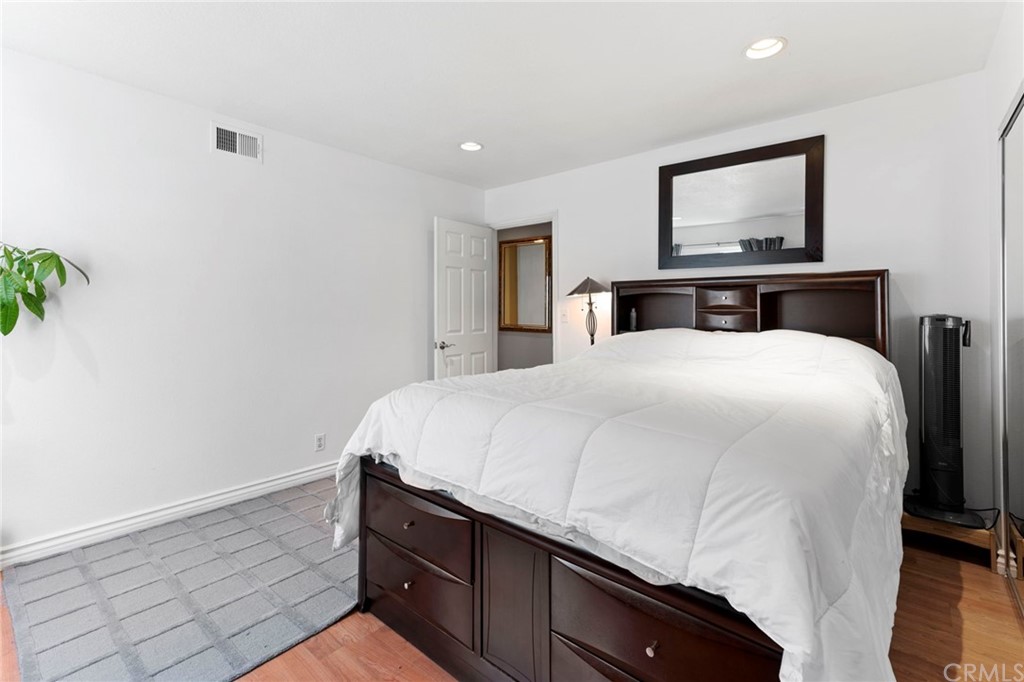 15 Calandria Irvine, CA 92620 - Photo 32 of 49 a bedroom with a bed and a painting on the wall