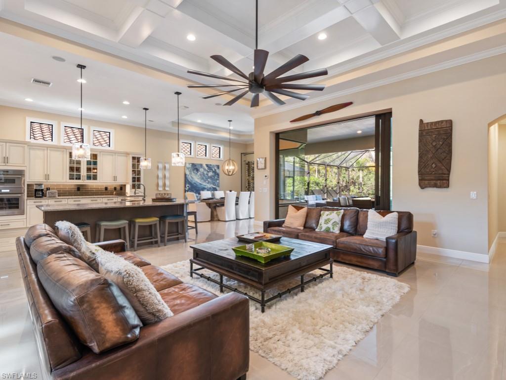 12766 Dundee Lane Naples, FL 34120 - Photo 12 of 37 a living room with furniture kitchen view and a large window