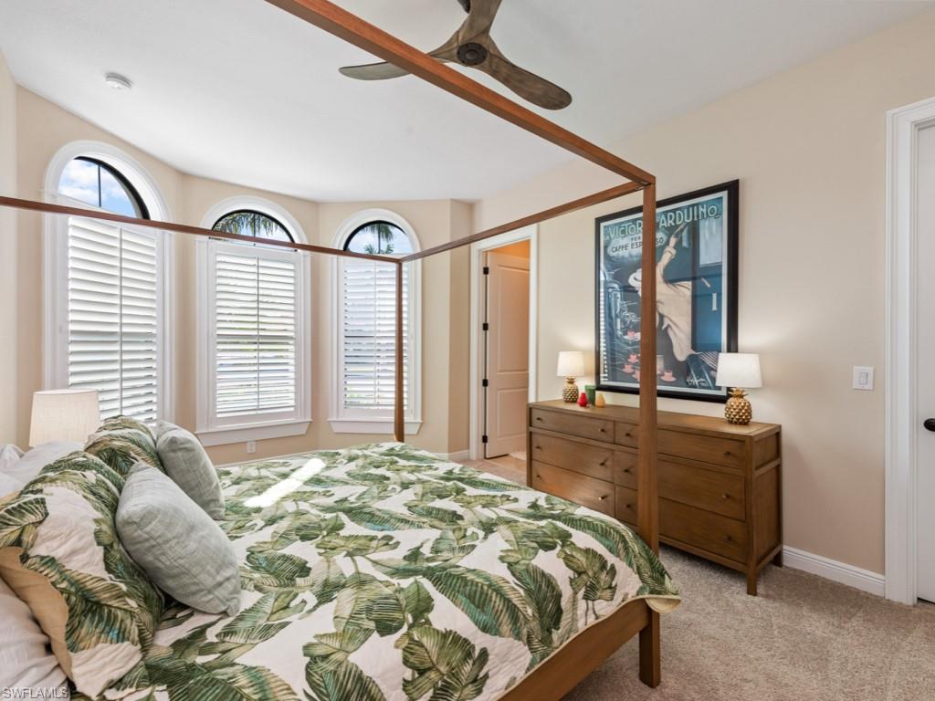 12766 Dundee Lane Naples, FL 34120 - Photo 16 of 37 a bedroom with a bed and a dresser