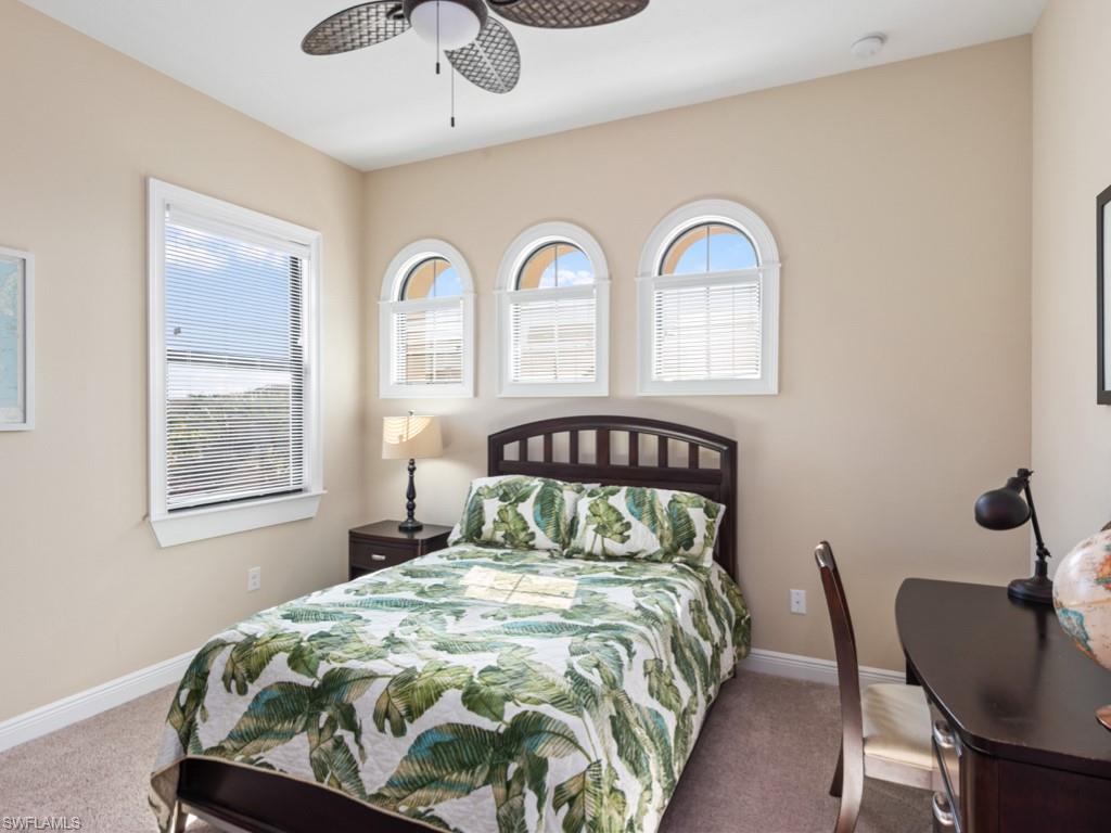 12766 Dundee Lane Naples, FL 34120 - Photo 17 of 37 a bedroom with a bed and chair