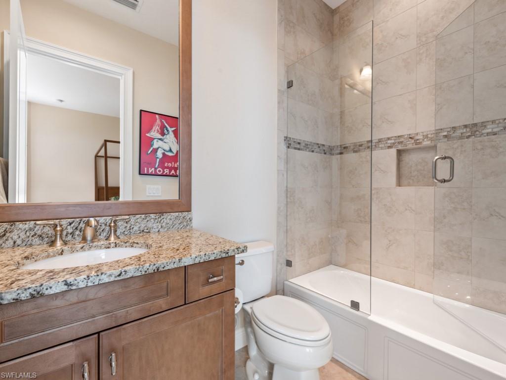 12766 Dundee Lane Naples, FL 34120 - Photo 18 of 37 a bathroom with a sink a toilet and shower