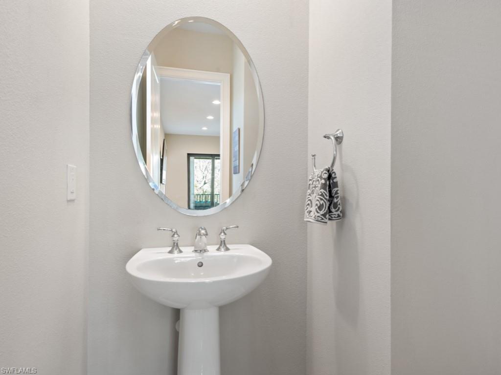 12766 Dundee Lane Naples, FL 34120 - Photo 20 of 37 a bathroom with a sink and a mirror
