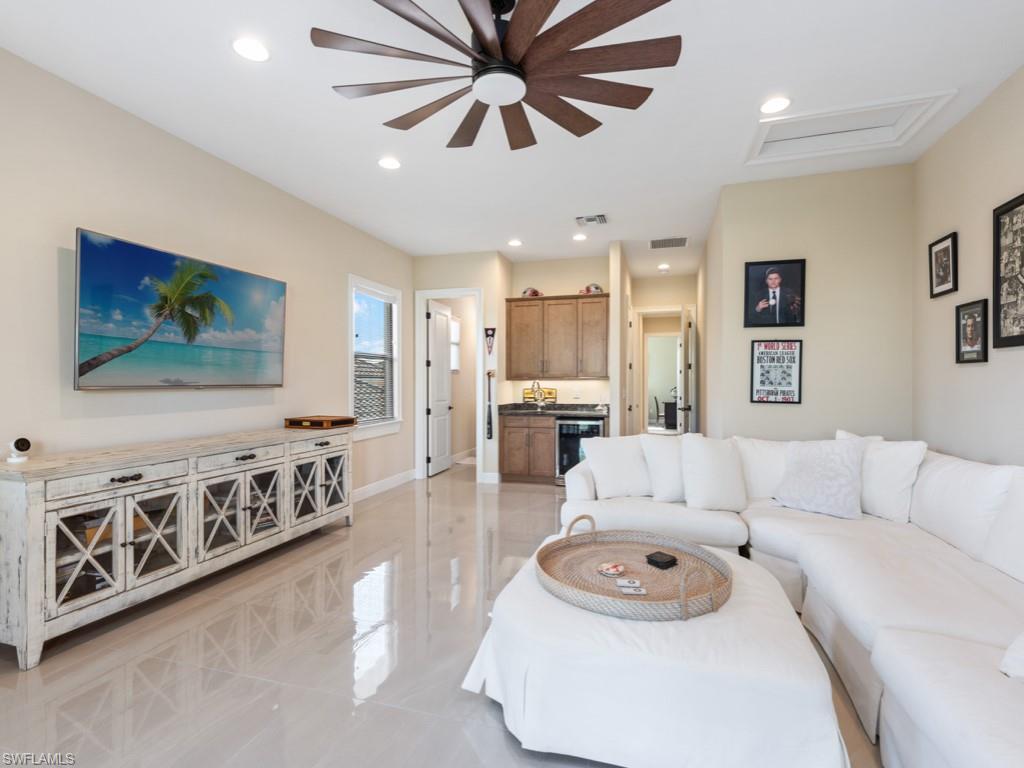 12766 Dundee Lane Naples, FL 34120 - Photo 21 of 37 a living room with furniture and a flat screen tv