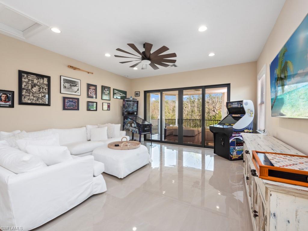 12766 Dundee Lane Naples, FL 34120 - Photo 22 of 37 a living room with furniture and large windows