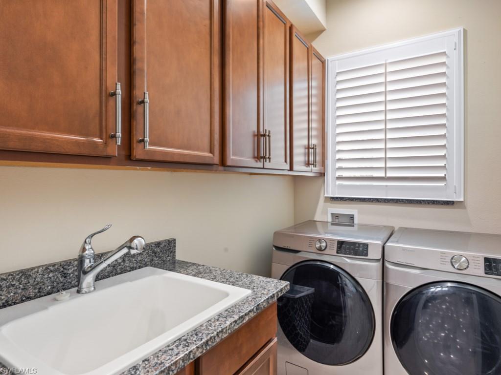 12766 Dundee Lane Naples, FL 34120 - Photo 24 of 37 a bathroom with a granite countertop sink and a washing machine