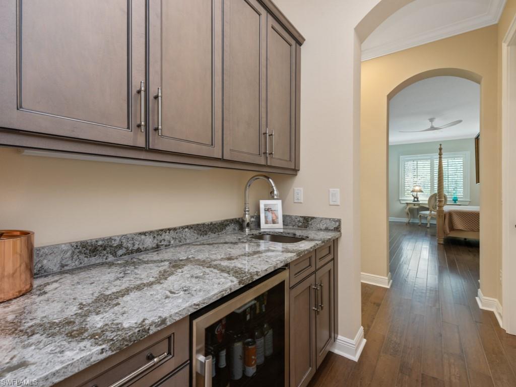 12766 Dundee Lane Naples, FL 34120 - Photo 25 of 37 a kitchen with granite countertop a sink and cabinets