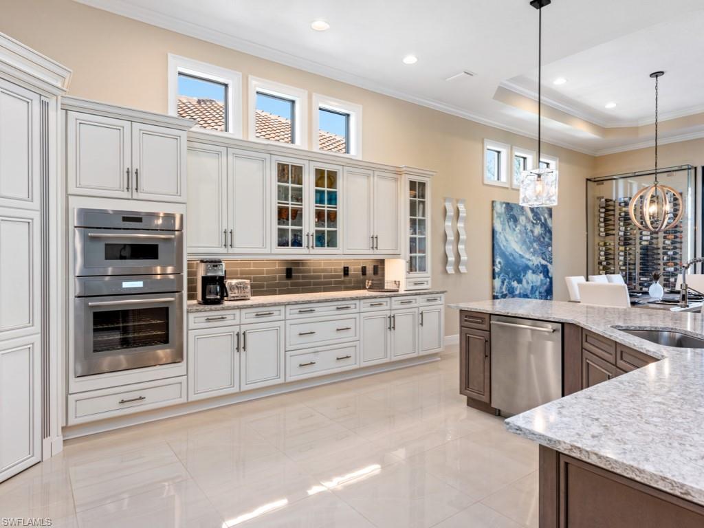 12766 Dundee Lane Naples, FL 34120 - Photo 5 of 37 a kitchen with granite countertop a sink stainless steel appliances and cabinets