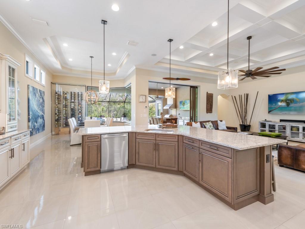 12766 Dundee Lane Naples, FL 34120 - Photo 6 of 37 a large kitchen with lots of counter space a sink appliances and living room view