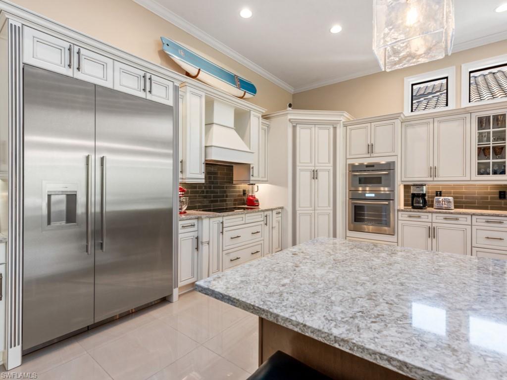 12766 Dundee Lane Naples, FL 34120 - Photo 8 of 37 a kitchen with stainless steel appliances granite countertop a refrigerator and a stove top oven