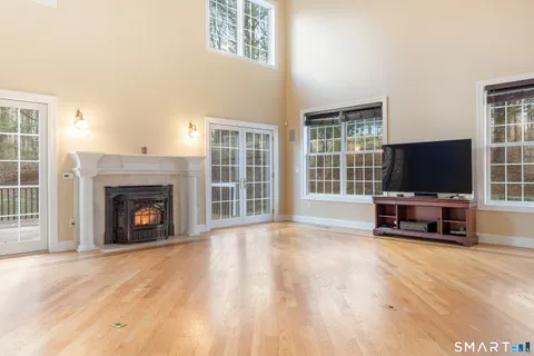 a view of living room with furniture flat screen tv and a fireplace