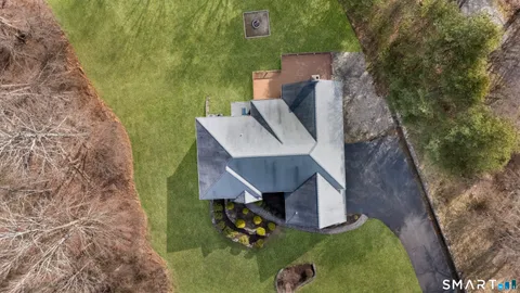 an aerial view of a house with a yard