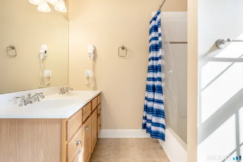a white toilet sitting next to a shower curtain