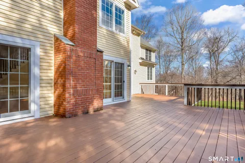 a view of backyard with deck and wooden floor