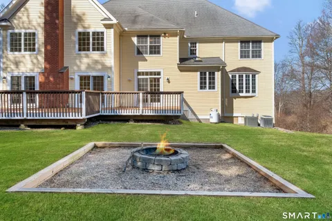 a view of a house with backyard and wooden fence