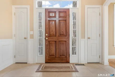 a view of entryway and hall with wooden floor