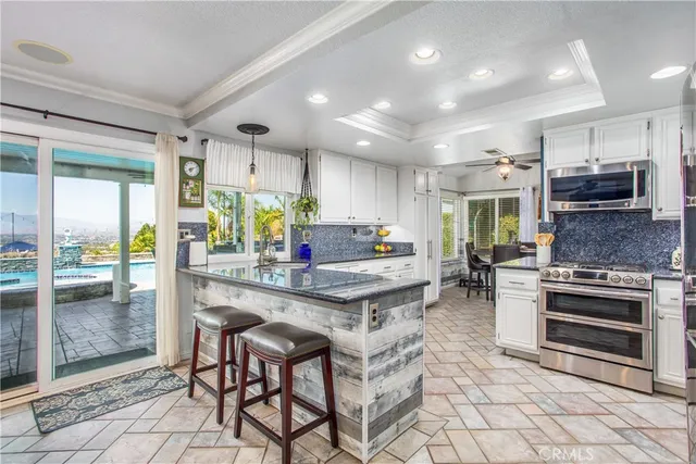 a kitchen with stainless steel appliances granite countertop a refrigerator and a sink