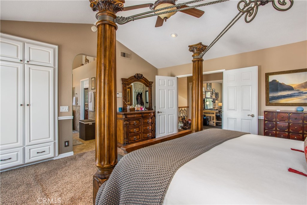 16455 Lake Knoll Parkway Riverside, CA 92503 - Photo 22 of 59 a large bedroom with a bed and a chandelier