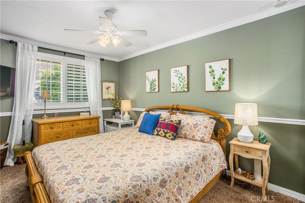 16455 Lake Knoll Parkway Riverside, CA 92503 - Photo 31 of 59 a bedroom with a bed and a chandelier