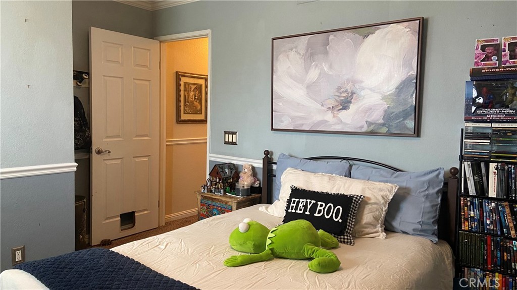 16455 Lake Knoll Parkway Riverside, CA 92503 - Photo 34 of 59 a bedroom with a bed and cupboard