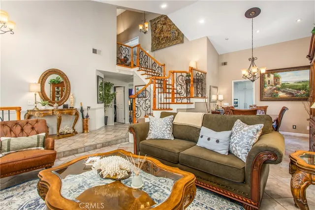 a living room with furniture a rug and a chandelier
