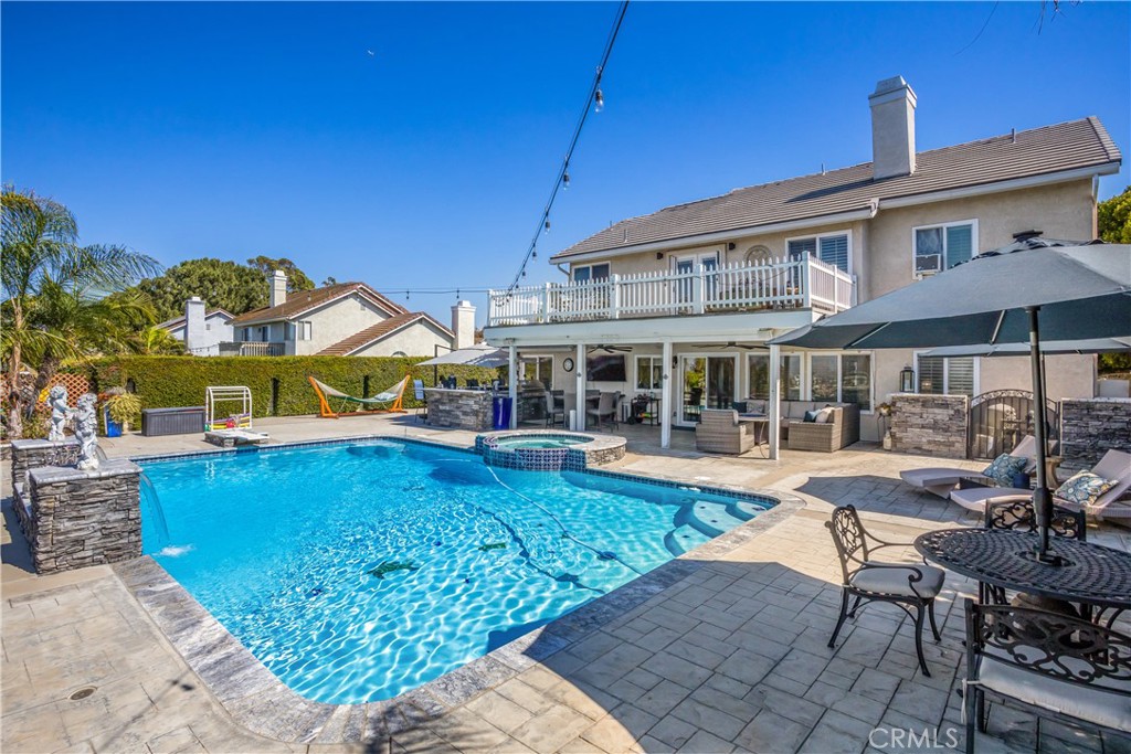 16455 Lake Knoll Parkway Riverside, CA 92503 - Photo 42 of 59 a view of a house with swimming pool lawn chairs under an umbrella