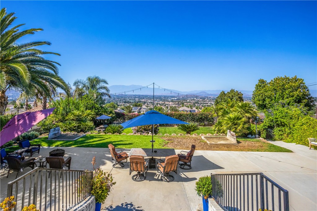 16455 Lake Knoll Parkway Riverside, CA 92503 - Photo 44 of 59 a view of a patio with furniture and table under an umbrella