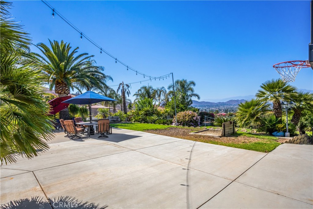 16455 Lake Knoll Parkway Riverside, CA 92503 - Photo 45 of 59 a view of a patio with a table and chairs under an umbrella